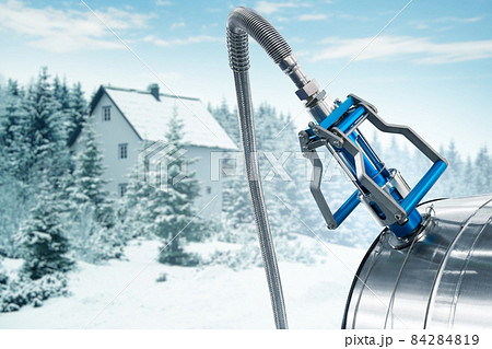 CNG nozzle with gas tank on a background of winter house 84284819