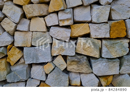 View of the stone wall of the fence, background, texture of the stone. 84284890