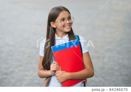 Endearing geekiness. Happy child in glasses hold books. Endearing geekiness. Happy child in glasses hold books. 84286070