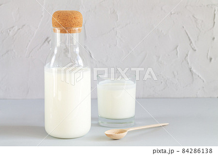Jar of organic yogurt or kefir with glass and spoon Jar of organic yogurt or kefir with glass and spoon 84286138