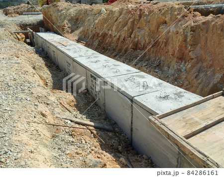 SELANGOR, MALAYSIA -JANUARY 22, 2021: Underground precast concrete box culvert drain under construction at the construction site. It is used to channel stormwater to prevent flash floods. SELANGOR, MALAYSIA -JANUARY 22, 2021: Underground precast concrete box culvert drain under construction at the construction site. It is used to channel stormwater to prevent flash floods. 84286161