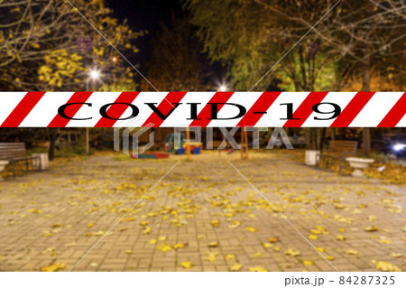 Coronavirus in Moscow, Russia. An empty playground on an autumn night in one of the residential areas (blurry view). Covid-19 sign. Concept of COVID pandemic and travel. Coronavirus in Moscow, Russia. An empty playground on an autumn night in one of the residential areas (blurry view). Covid-19 sign. Concept of COVID pandemic and travel. 84287325