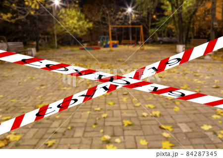 Coronavirus in Moscow, Russia. An empty playground on an autumn night in one of the residential areas (blurry view). Covid-19 sign. Concept of COVID pandemic and travel. Coronavirus in Moscow, Russia. An empty playground on an autumn night in one of the residential areas (blurry view). Covid-19 sign. Concept of COVID pandemic and travel. 84287345
