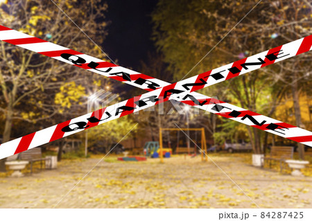 Coronavirus in Moscow, Russia. An empty playground on an autumn night in one of the residential areas (blurry view). Quarantine sign. Concept of COVID pandemic and travel 84287425