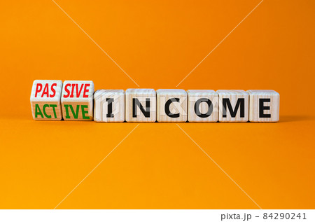 Passive or active income symbol. Turned cubes and changed words passive income to active income. Beautiful orange background, copy space. Business, passive or active income concept. Passive or active income symbol. Turned cubes and changed words passive income to active income. Beautiful orange background, copy space. Business, passive or active income concept. 84290241