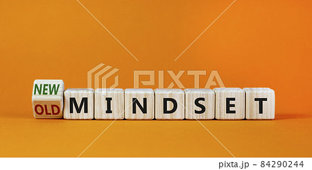 New vs old mindset symbol. Turned the wooden cube and changed words 'old mindset' to 'new mindset'. Beautiful orange background. Business, new or old mindset concept. Copy space. 84290244