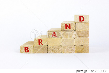 Brand symbol. Concept word 'brand' on wooden cubes on a beautiful white table. White background. Business and brand concept. Copy space. Brand symbol. Concept word 'brand' on wooden cubes on a beautiful white table. White background. Business and brand concept. Copy space. 84290345