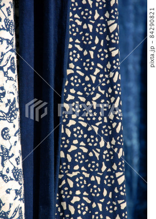 Wuzhen Water Town, Zhejiang Province, China. Indigo blue and white printed calico - a traditional cotton fabric produced in Wuzhen and a souvenir purchase for tourists. Wuzhen Water Town, Zhejiang Province, China. Indigo blue and white printed calico - a traditional cotton fabric produced in Wuzhen and a souvenir purchase for tourists. 84290821