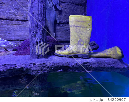 Rubber boots or gumboots underwater on sand ground 84290907