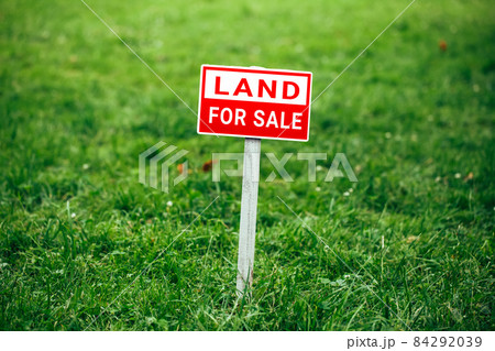 land for sale plate sign, green grass background land for sale plate sign, green grass background 84292039