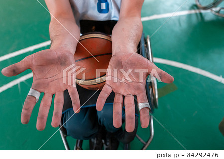 the hands of disabled basketball players after an exhausting game in the arena. Selective focus  84292476