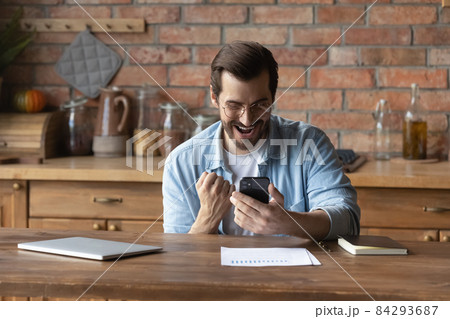 Excited man check email on smartphone receive attractive job offer Excited man check email on smartphone receive attractive job offer 84293687