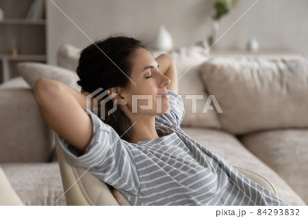 Close up peaceful woman with closed eyes relaxing in chair Close up peaceful woman with closed eyes relaxing in chair 84293832