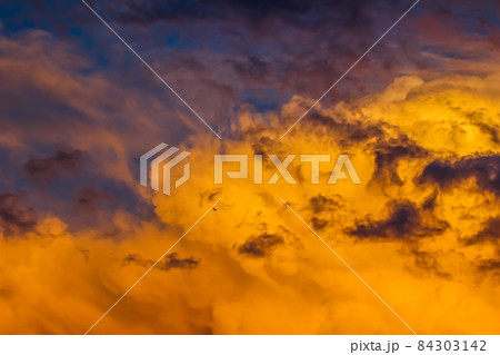 Background from a bright colorful sunset with clouds and a flying bird. High quality photo Background from a bright colorful sunset with clouds and a flying bird. High quality photo 84303142