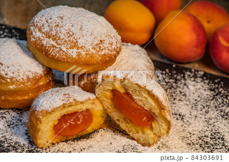 Freshly cooked Apricot jam doughnuts, referred to as jelly doughnuts, donuts in the US Freshly cooked Apricot jam doughnuts, referred to as jelly doughnuts, donuts in the US 84303691