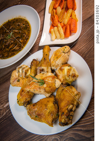 Chicken Hunter recipe with glazed root vegetables, carrot, turnip with its mushroom sauce deglazed 84303692
