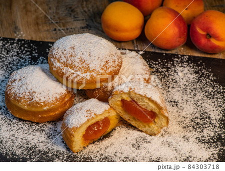 Freshly cooked Apricot jam doughnuts, referred to as jelly doughnuts, donuts in the US Freshly cooked Apricot jam doughnuts, referred to as jelly doughnuts, donuts in the US 84303718