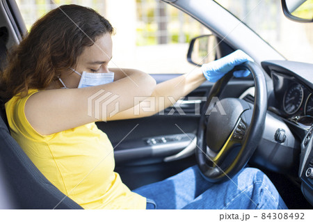 Young woman sneezing in the car 84308492