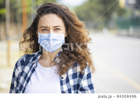 Young woman in medical face protection mask 84308496
