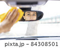 Young woman disinfecting her car 84308501