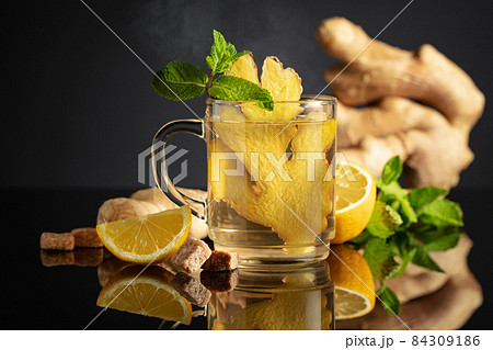 Ginger tea with ingredients on a black background. 84309186