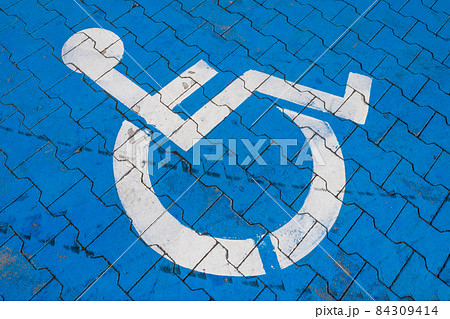 Cracked handicap sign on parking lot 84309414