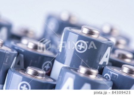 Close up set of alkaline battery size AA with focus on positive sign of one of them Close up set of alkaline battery size AA with focus on positive sign of one of them 84309423