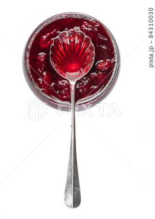 Sweet cherry confiture with spoon isolated on white background 84310030