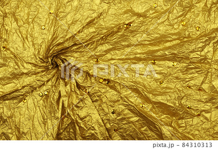 Draped crumpled golden tissue paper with sequins 84310313