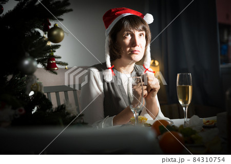 Girl is bored alone in New Year night Girl is bored alone in New Year night 84310754