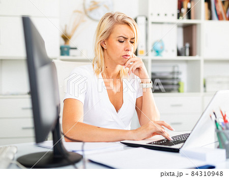 Tired businesswoman working with documents in office 84310948