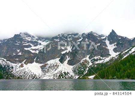 Beautiful view of the mountain lake on a foggy morning. Beautiful view of the mountain lake on a foggy morning. 84314504