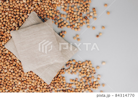 Set of cherry stone pillows, cherry pit filled pillow on cherry stones background with copy space on gray. Natural heat or cool pack. Alternative medicine and therapy, pit sack for spa massage 84314770