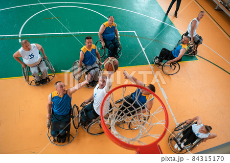 a photo of basketball teams with disabilities with the selector in the big hall before the start of the basketball game a photo of basketball teams with disabilities with the selector in the big hall before the start of the basketball game 84315170