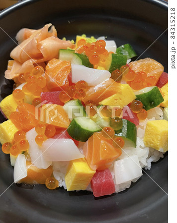 Close up of favorited japanese food called chirashi sushi made by mixed and put fresh seafood on sushi rice in the bowl. Close up of favorited japanese food called chirashi sushi made by mixed and put fresh seafood on sushi rice in the bowl. 84315218