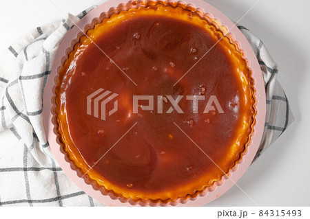 Classic cheesecake with caramel sauce on white plate on gray background. Copy space for text. 84315493