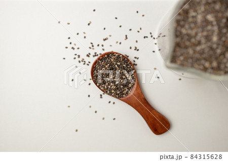 Chia seeds in wooden spoon and cup from top view with space on white background Chia seeds in wooden spoon and cup from top view with space on white background 84315628