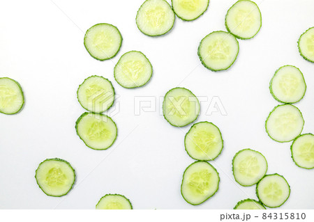 Cucumber with many round slices. Top view. Flat lay pattern 84315810