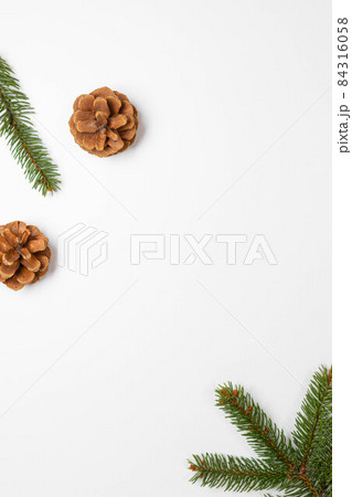 New Year composition. Pine cones with nature evergreen fir sprigs on a white background. Christmas, winter, new year concept. Flat lay, top view 84316058