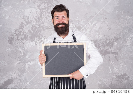 Man good looking hipster cafe barista with blackboard copy space, business contacts concept Man good looking hipster cafe barista with blackboard copy space, business contacts concept 84316438