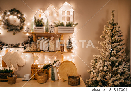 Christmas decor. garlands on shelves on decorated in kitchen for new year.  84317001
