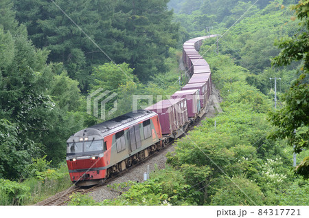 S字カーブに身をくねらせて慎重に坂を下っていく貨物列車 84317721