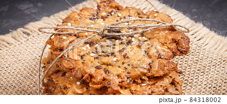 Fresh baked oatmeal cookies with honey and healthy seeds. Delicious crunchy dessert Fresh baked oatmeal cookies with honey and healthy seeds. Delicious crunchy dessert 84318002