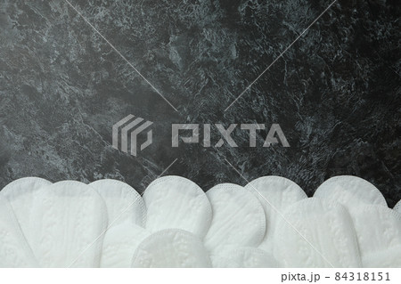 Sanitary pads on black smokey background, space for text Sanitary pads on black smokey background, space for text 84318151