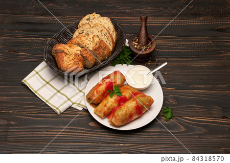 Portion of stuffed cabbage rolls on wooden table Portion of stuffed cabbage rolls on wooden table 84318570