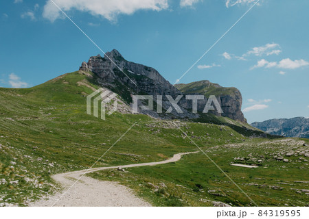 Amaizing view on Durmitor mountains, National Park, Mediterranean, Montenegro, Balkans, Europe. Bright summer view from Sedlo pass. The road near the house in the mountains. 84319595