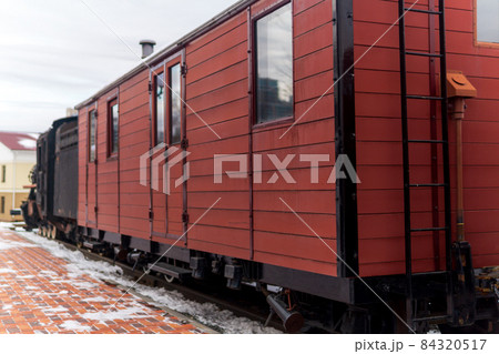 vintage boxcar with a steam locomotive at the station in winter vintage boxcar with a steam locomotive at the station in winter 84320517