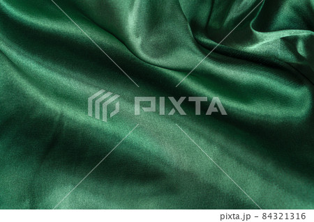 Elegant smooth green silk or satin folds closeup. Cloth texture background. Abstract wallpaper. Trendy mint green backdrop for web design. Luxury twisted fabric backplate Elegant smooth green silk or satin folds closeup. Cloth texture background. Abstract wallpaper. Trendy mint green backdrop for web design. Luxury twisted fabric backplate 84321316