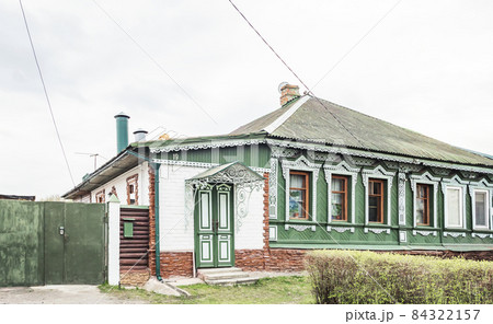 Wooden house in the traditional Russian style with carved platbands 84322157
