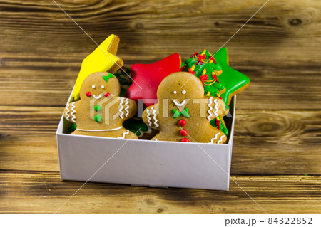 Tasty Christmas gingerbread cookies in box on wooden table Tasty Christmas gingerbread cookies in box on wooden table 84322852